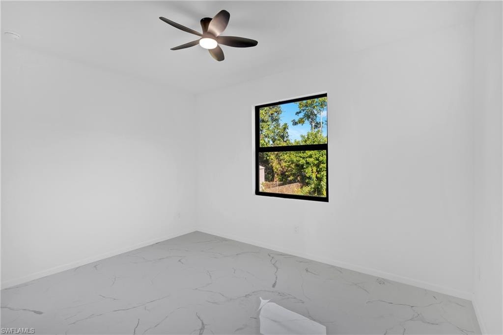 Recessed lighting, ceiling fan with integrated light, single window with black trim, and marble-look flooring