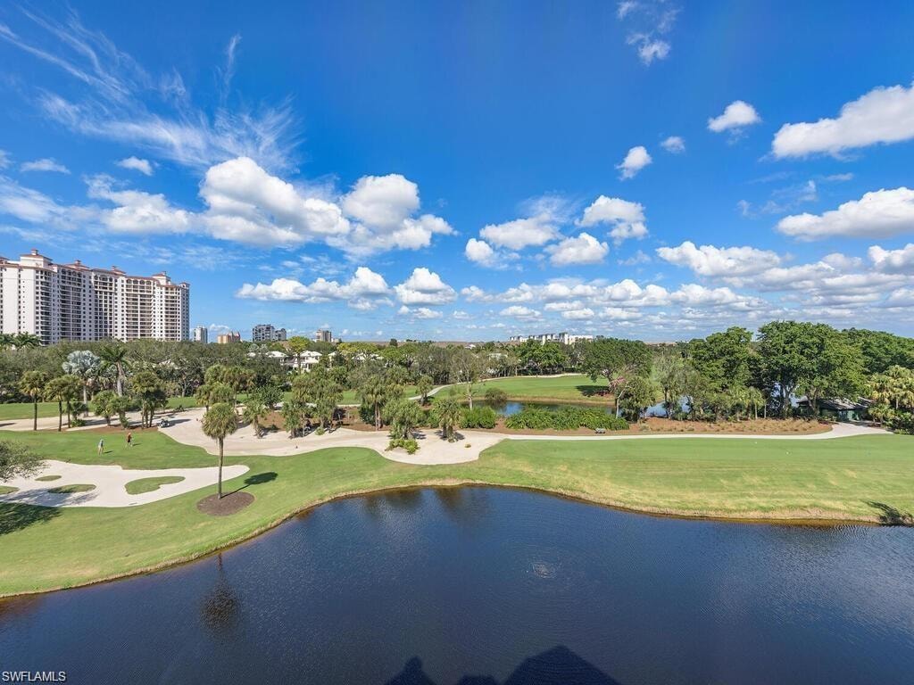 Surrounding community featuring a lawn and a water view