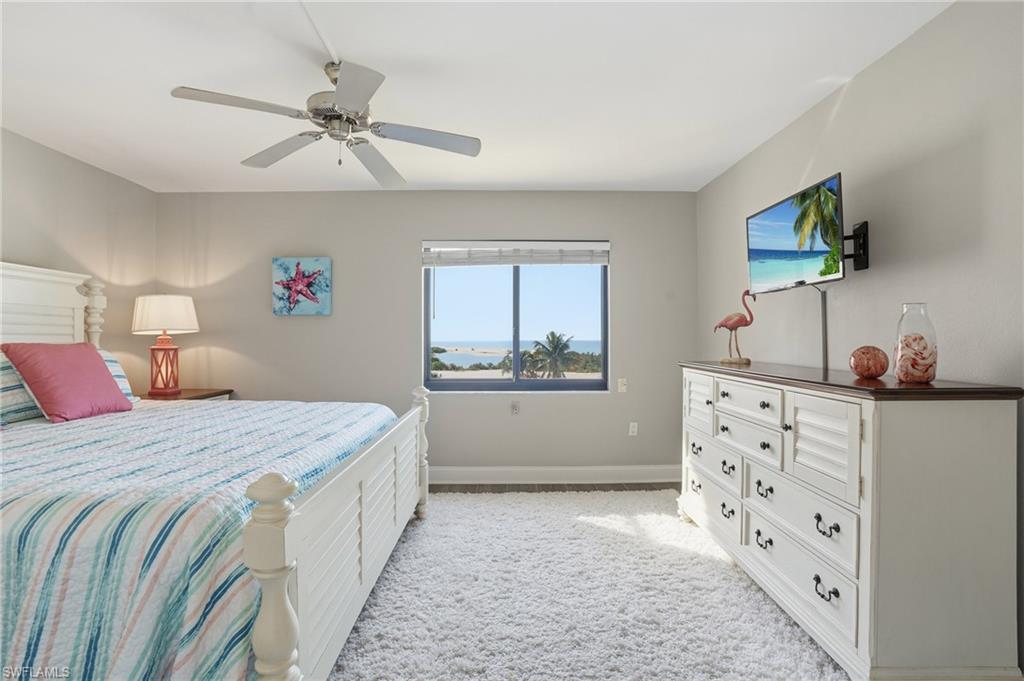 Bedroom featuring light colored carpet and ceiling fan