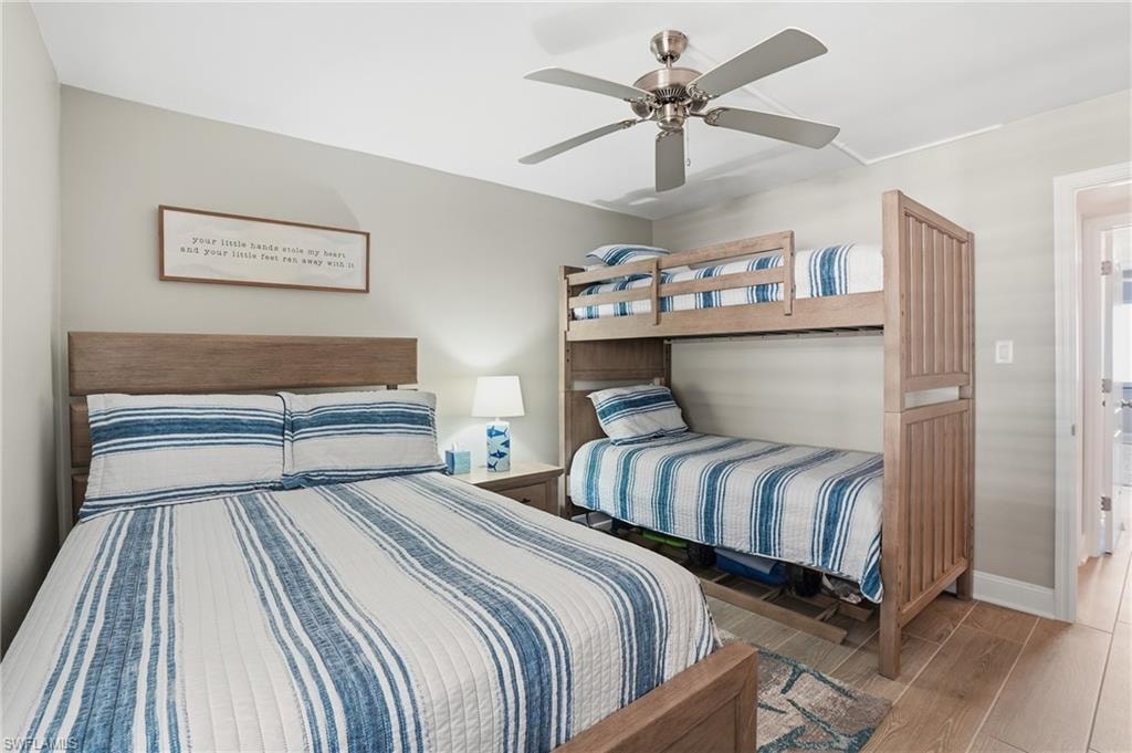 Bedroom with wood finished floors and a ceiling fan