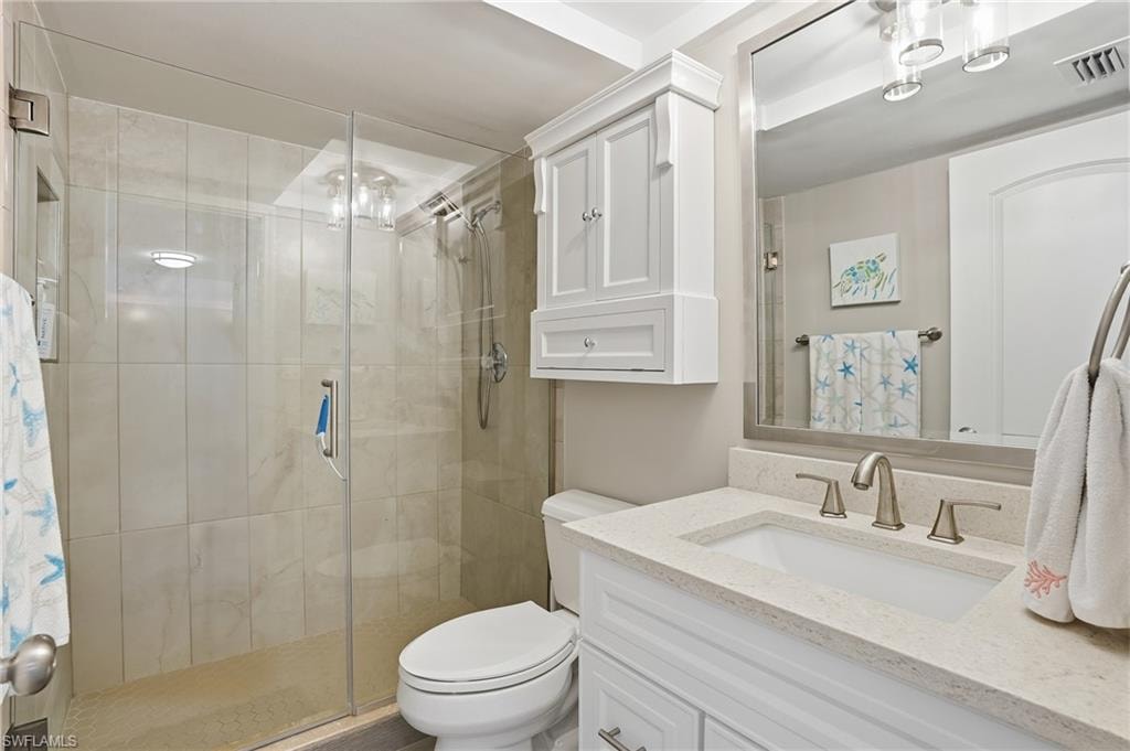 Bathroom featuring vanity and a shower stall