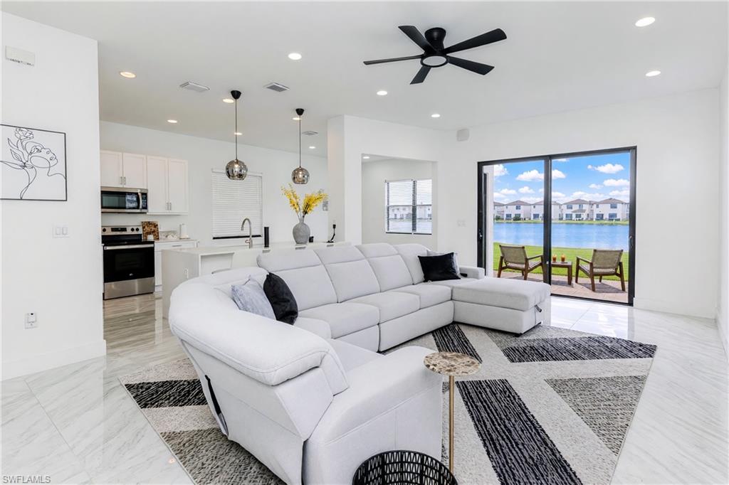 Open-concept living area with tile flooring and recessed lighting
