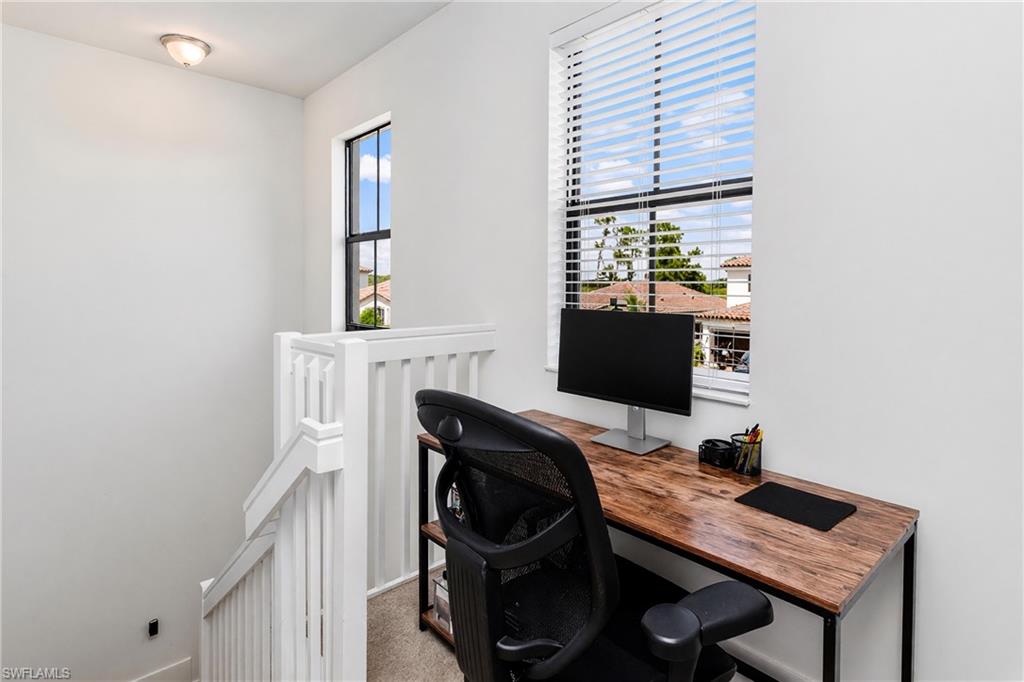 White painted railing, carpeted flooring, window with blinds, additional narrow window, flush mount ceiling fixture