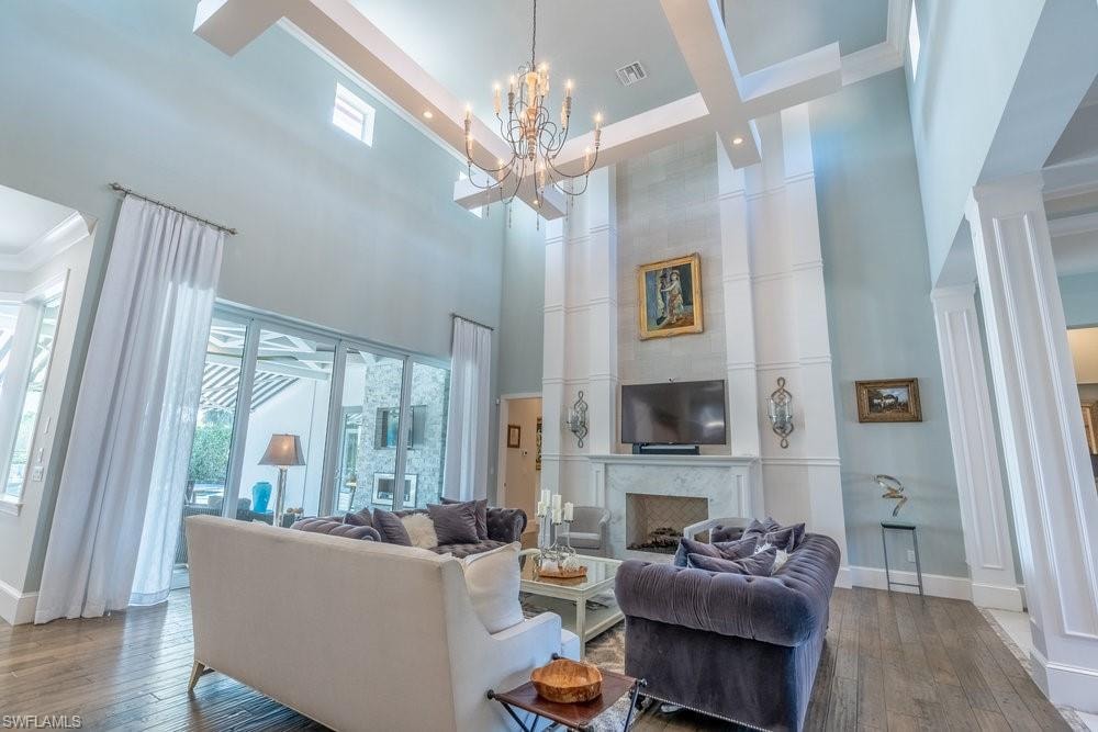 White floating beams suspended from the soaring 28-foot ceiling
