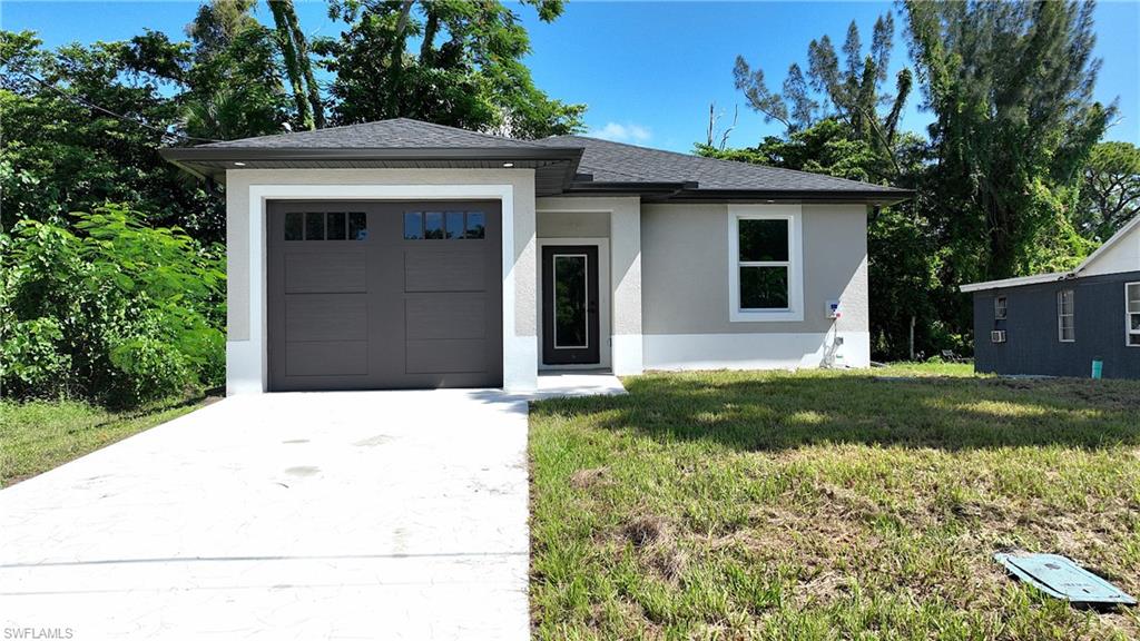 Contemporary exterior with a dark asphalt shingle roof, light grey stucco siding, and a dark grey paneled garage door with upper window inserts