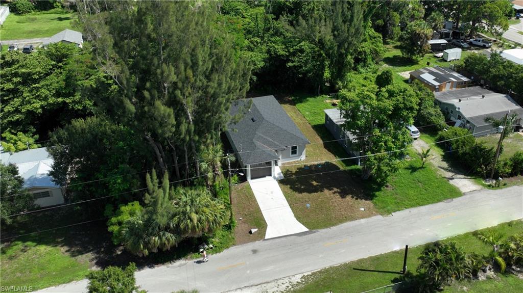 Single-story residence featuring a dark shingle roof and a light-colored exterior