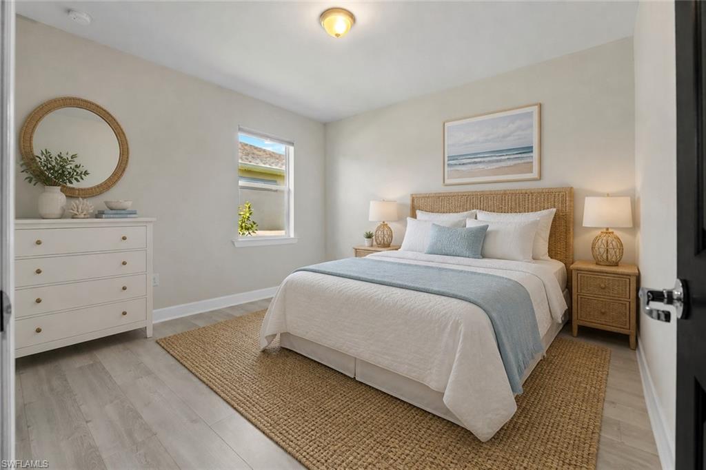 Wood-finish flooring, recessed lighting, and a window with a white frame
