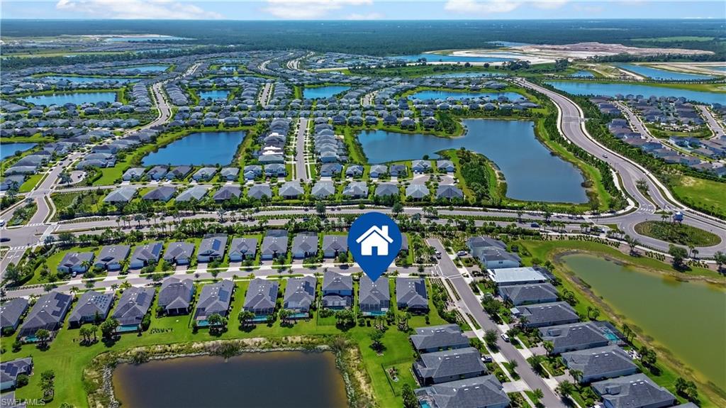 Expansive residential community featuring numerous homes, multiple water features, and an organized road network