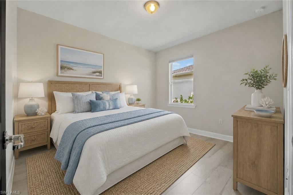 Light-toned walls, wood-finish flooring, and a single window with white trim