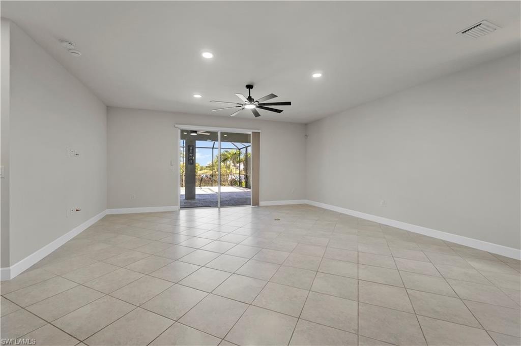 Neutral-toned tile flooring, recessed lighting, and a ceiling fan