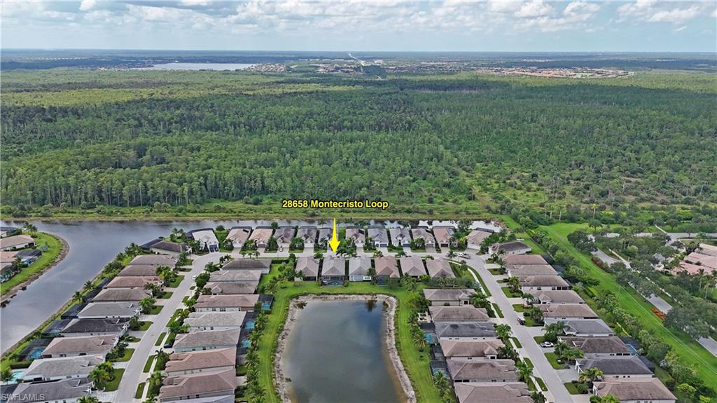 Aerial perspective of a structured community with a prominent water feature