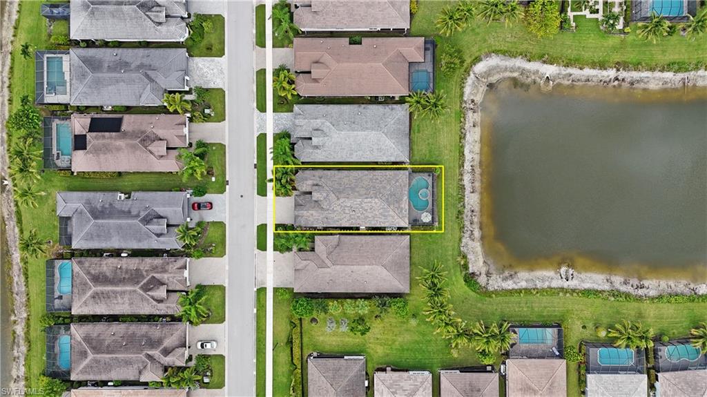 Property featuring a private swimming pool, direct pond access, and a paved driveway