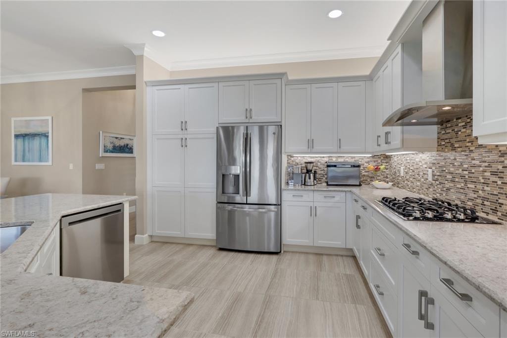 Full kitchen featuring light-toned cabinetry, stainless steel appliances, a gas cooktop, and light-toned countertops