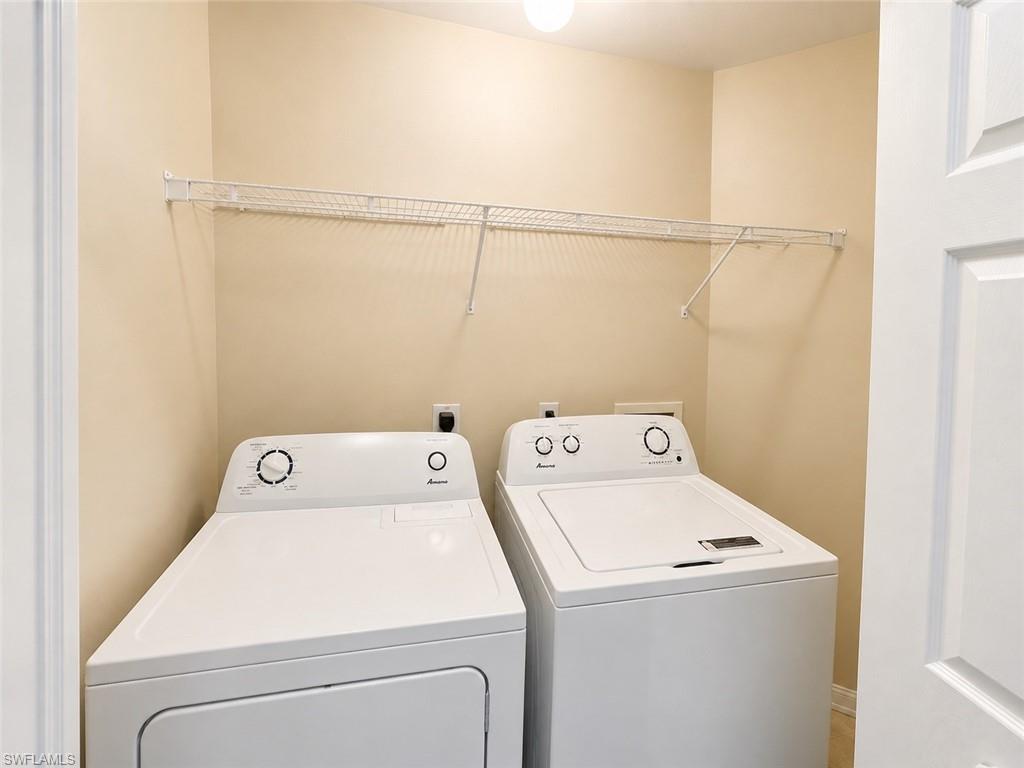 Laundry area featuring a wire storage shelf and light-colored walls