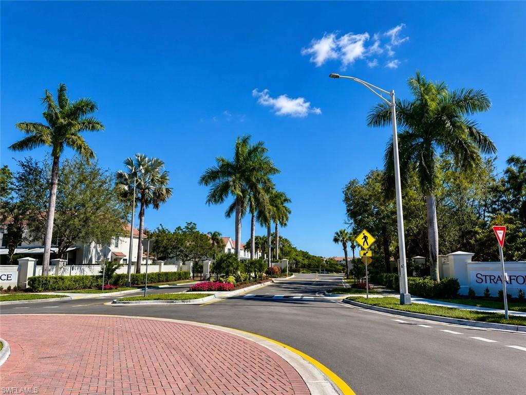 Paver driveway entrance with lush landscaping