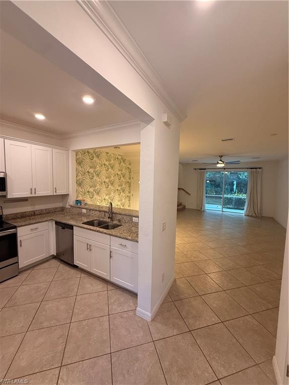 Kitchen featuring white cabinetry, stainless steel appliances, and stone countertops