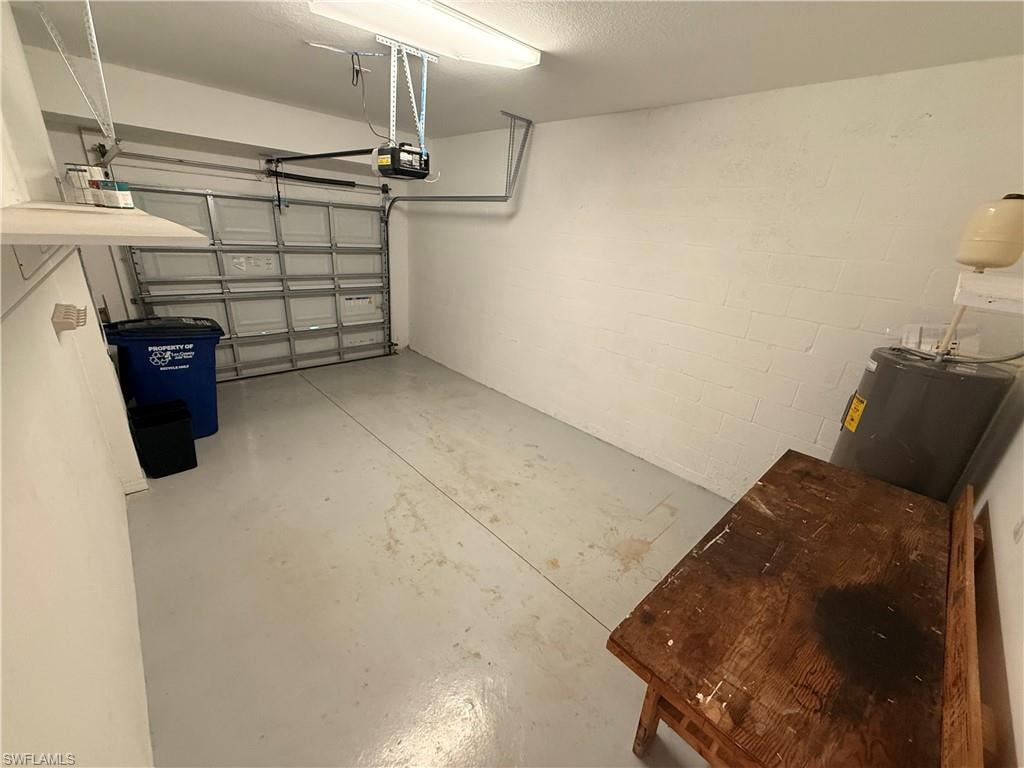 Attached garage with a roll-up door and an automatic opener