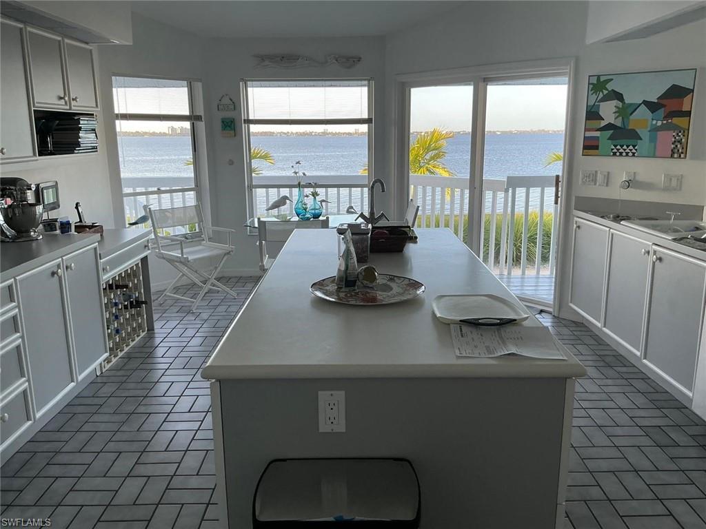 Kitchen with a central island and a water backdrop