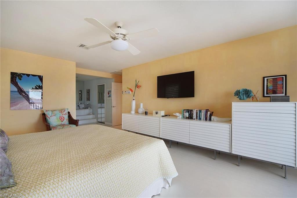 Bedroom featuring light-colored walls, white flooring, and a ceiling fan with integrated lighting