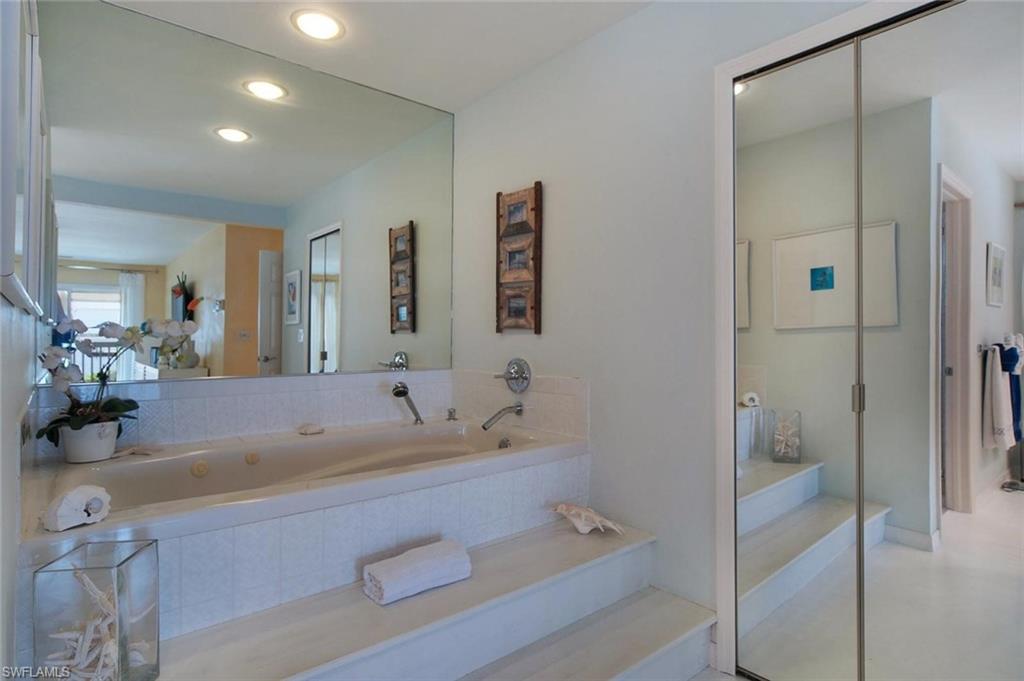 Built-in soaking tub with a tiled surround and tiered steps