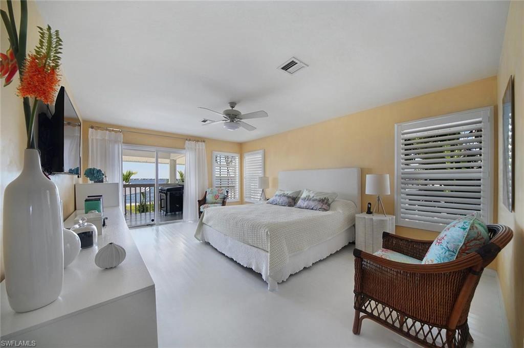 Spacious room featuring light-colored flooring and walls, with direct access to an outdoor area through sliding glass doors