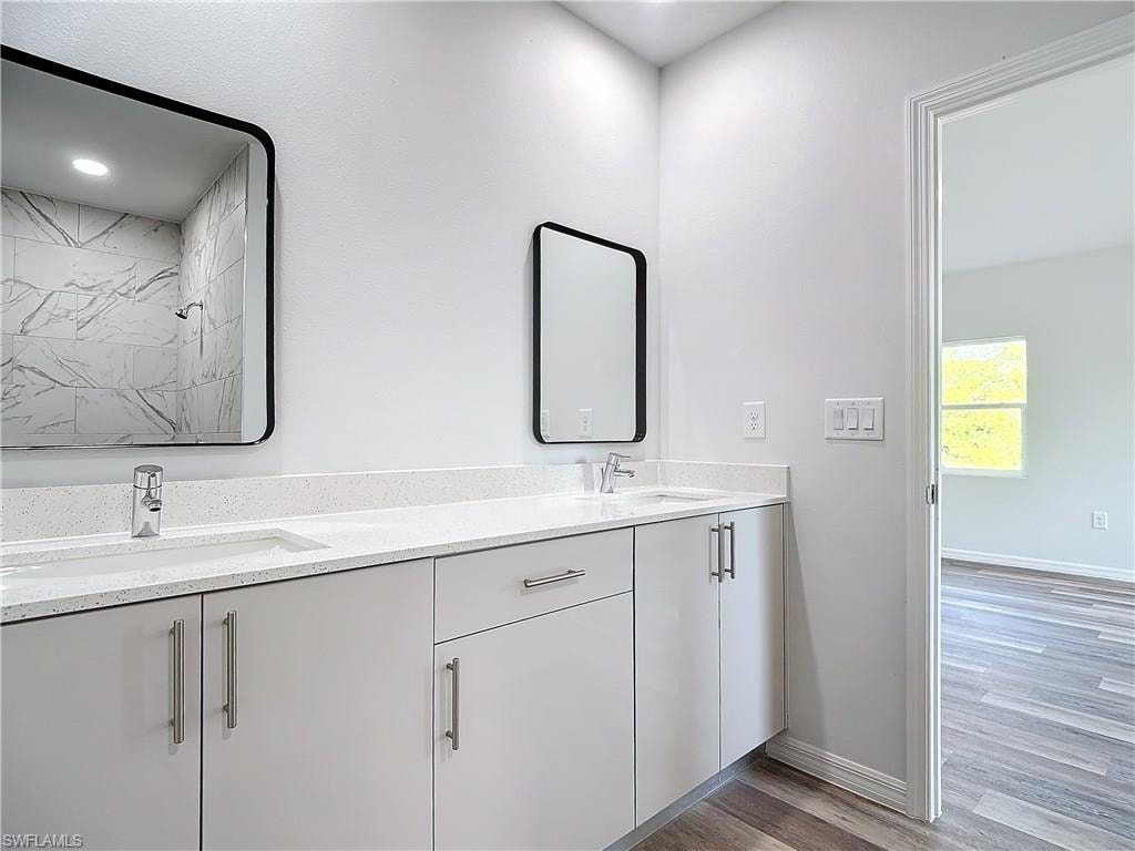 Bathroom with light wood-style floors and double vanity