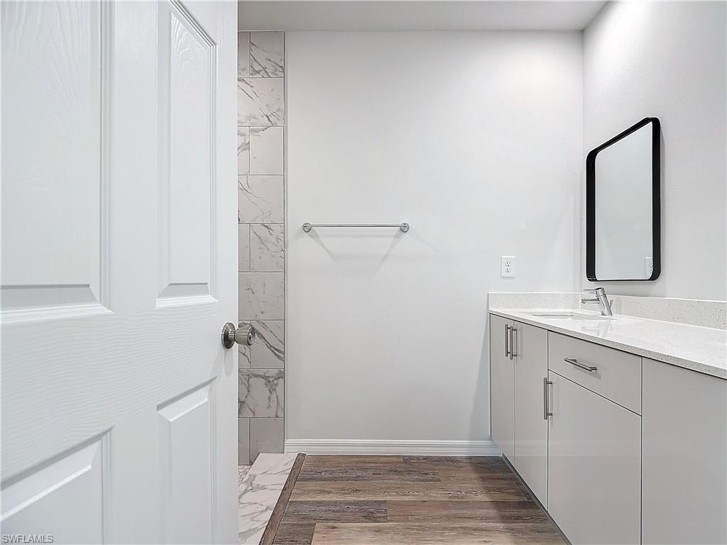 Bathroom featuring vanity and dark wood finished floors