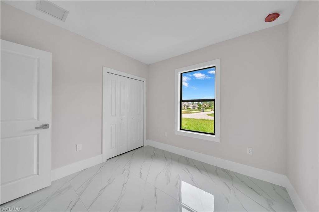Light-toned walls, white trim, and glossy tile flooring