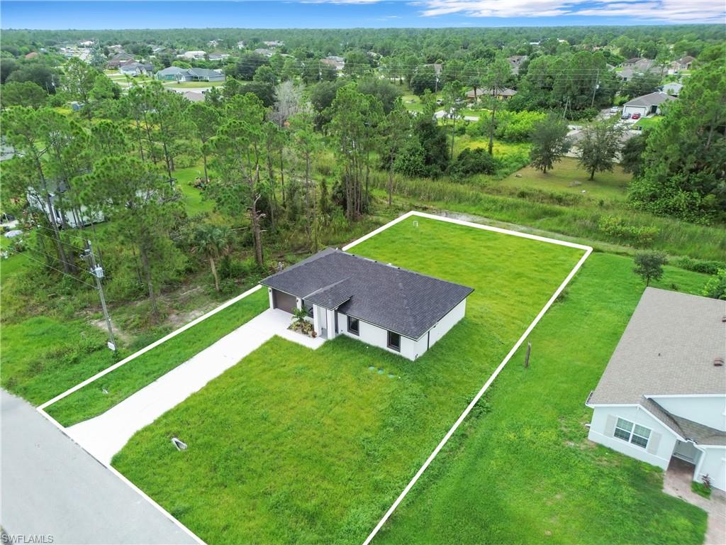 Single-story residence with a dark shingle roof, attached garage, and a concrete driveway