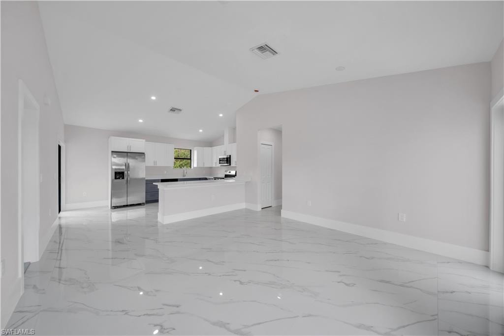 Open-concept living space with large format porcelain tile flooring