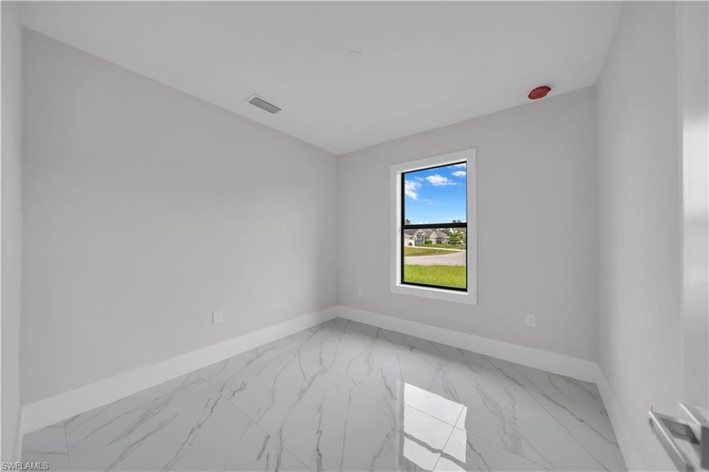 Window with black frame, white trim, and a high ceiling