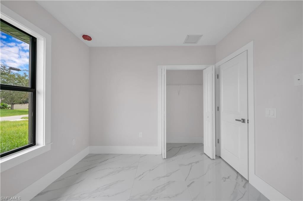 Contemporary interior with light-toned walls and sleek marble-finish tile flooring
