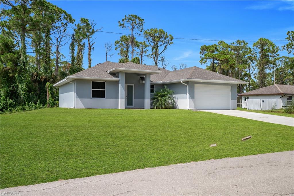 Contemporary single-story residence featuring a two-tone exterior, attached two-car garage, and a concrete driveway