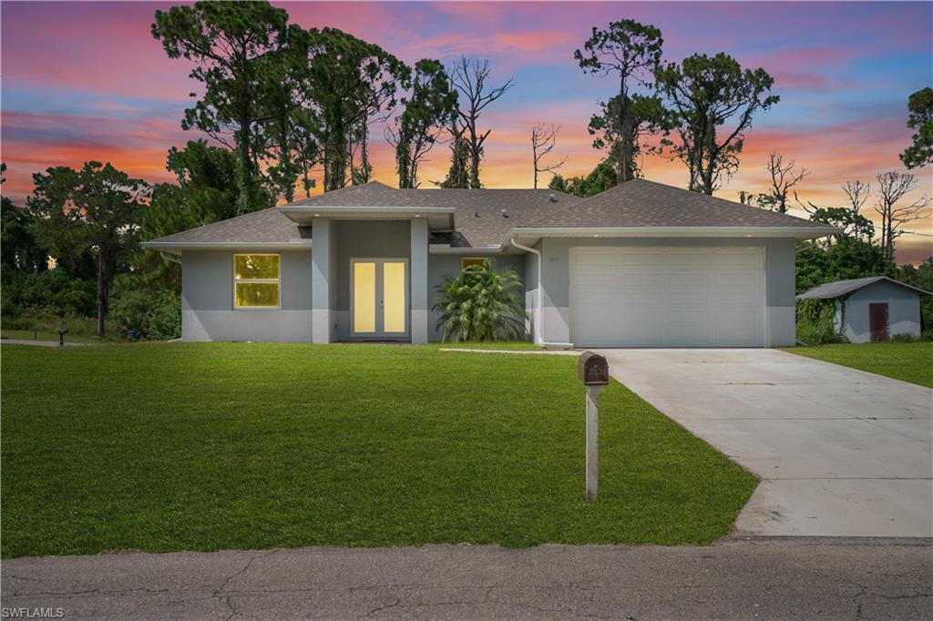 Exterior with dual front entry doors, attached garage, and a concrete driveway