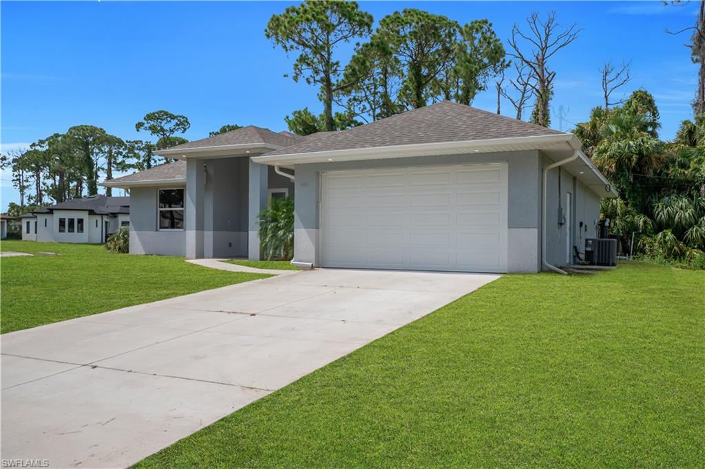 Single-story stucco exterior with a gray and white color palette