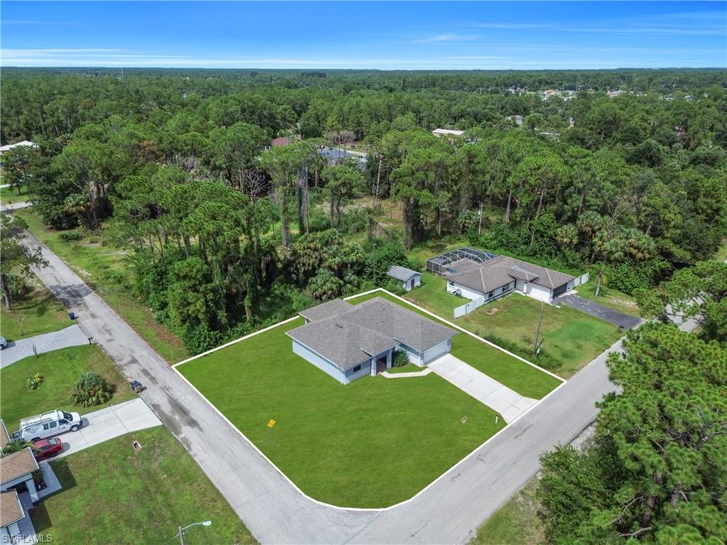 Single-story property with a corner lot, a paved driveway, and an attached garage