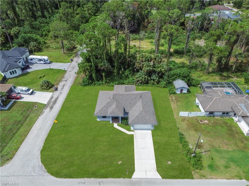 Single-story residence with a gray shingle roof, an attached two-car garage, and a concrete driveway