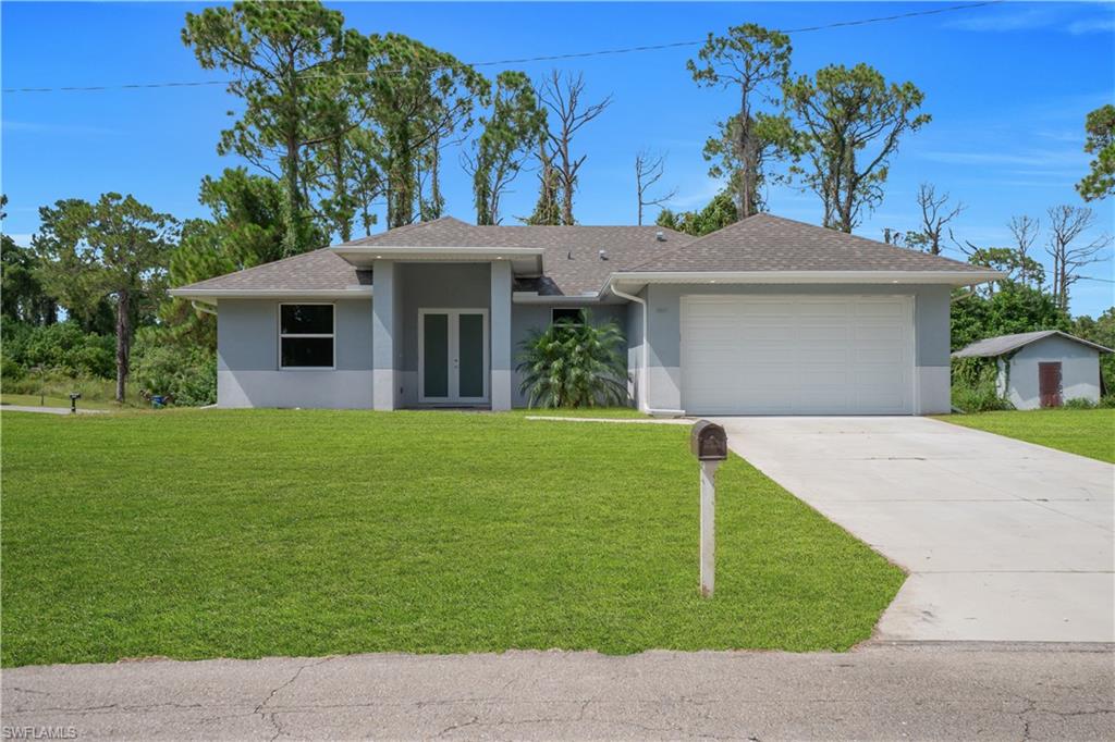 Contemporary exterior with a two-car garage, concrete driveway, and a covered front entry