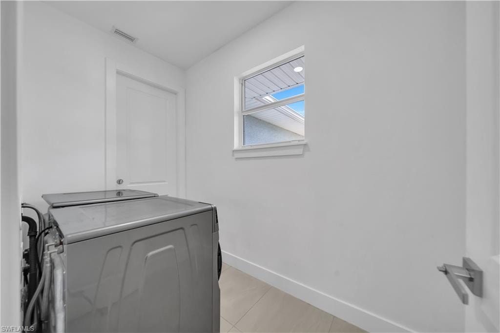 White interior walls with a single window and recessed lighting