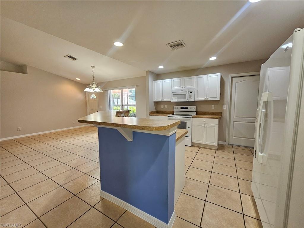 Kitchen featuring white cabinetry, light countertops, and tile flooring