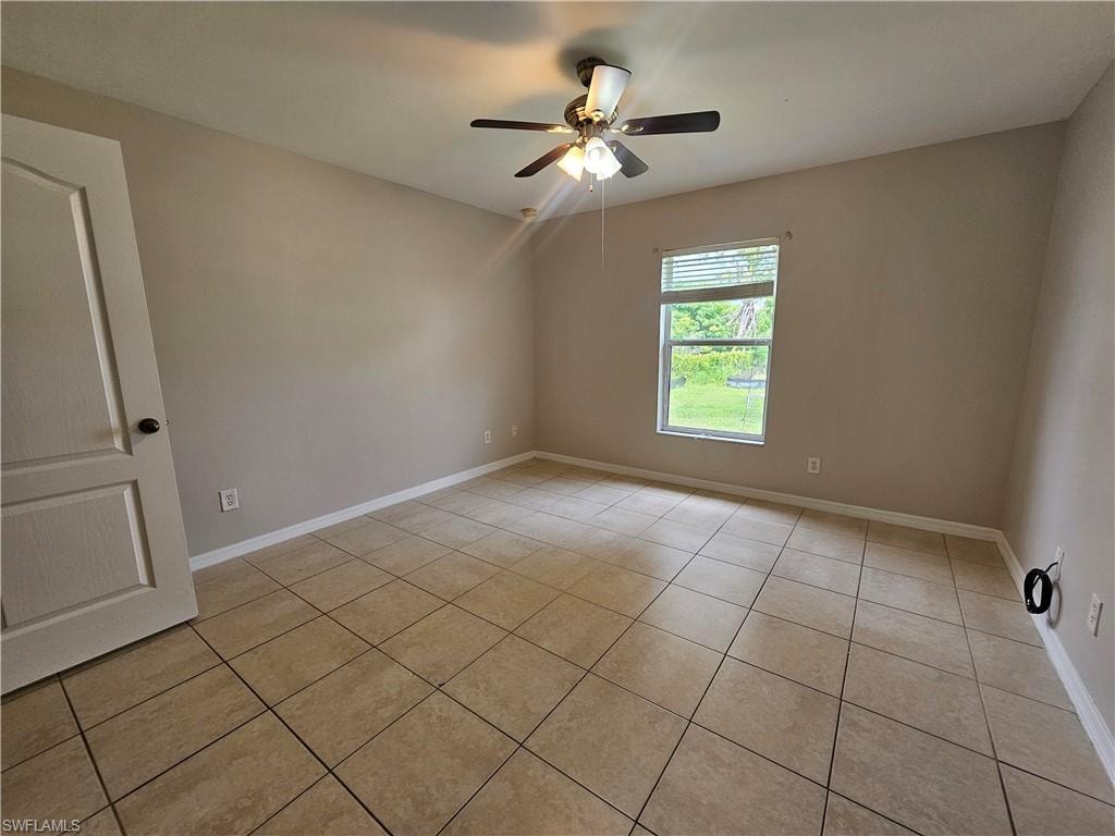 Tile flooring, neutral wall tones, ceiling fan with integrated lighting, and a window with blinds