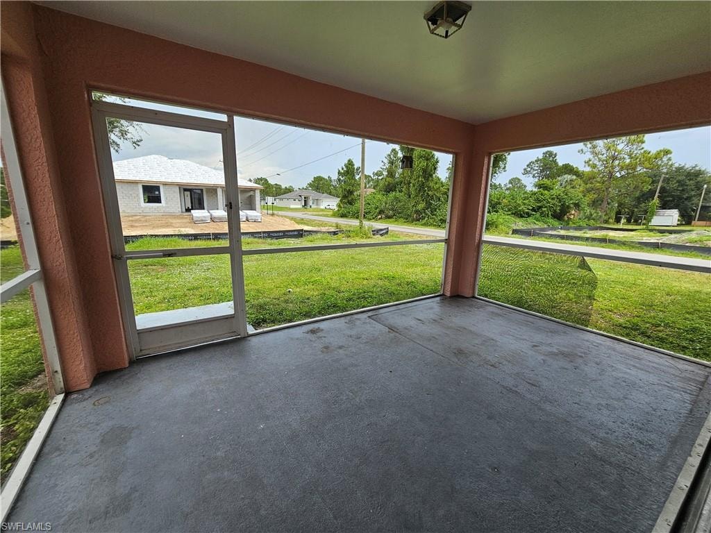 Screened outdoor living space with textured concrete flooring