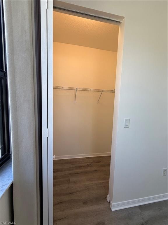 Closet with wood-finish flooring, white walls, and wire shelving
