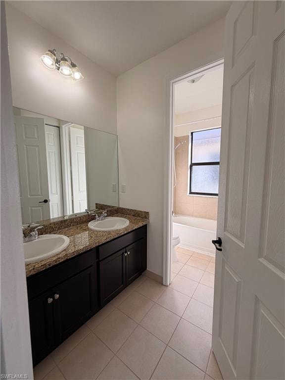 Dual vanity with granite countertop, integrated sinks, chrome faucets, and dark wood-finish cabinetry