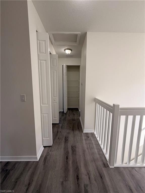 Wood-finish flooring throughout, white interior doors, and a white baluster railing