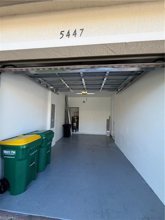 Garage space with a blue-hued concrete floor and white painted walls