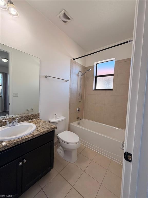 Bathroom featuring a single vanity with stone-finish countertop, dark wood-finish cabinetry, and a full-size bathtub with tile surround