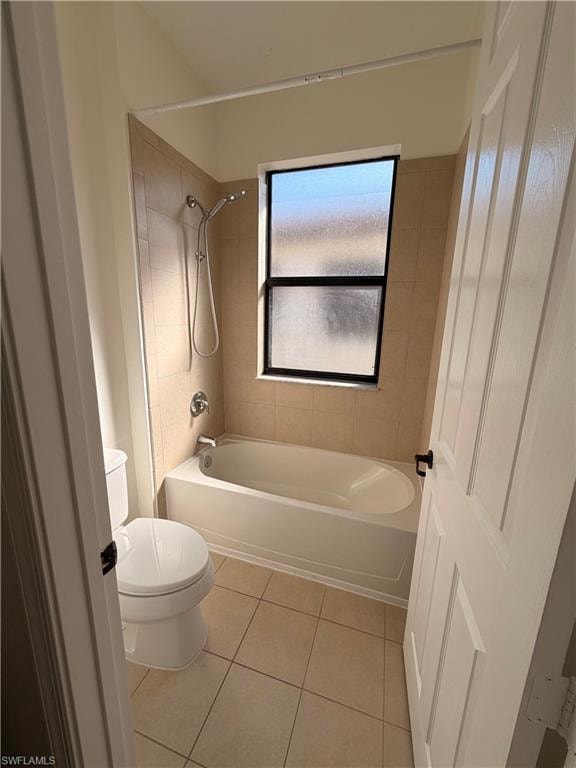 Full bathtub with integrated shower, chrome fixtures, and tiled surround