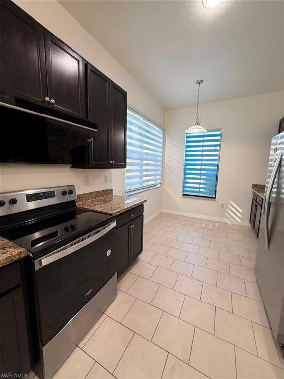 Kitchen featuring dark wood-finish cabinetry, granite-style countertops, stainless-steel appliances, and ceramic tile flooring
