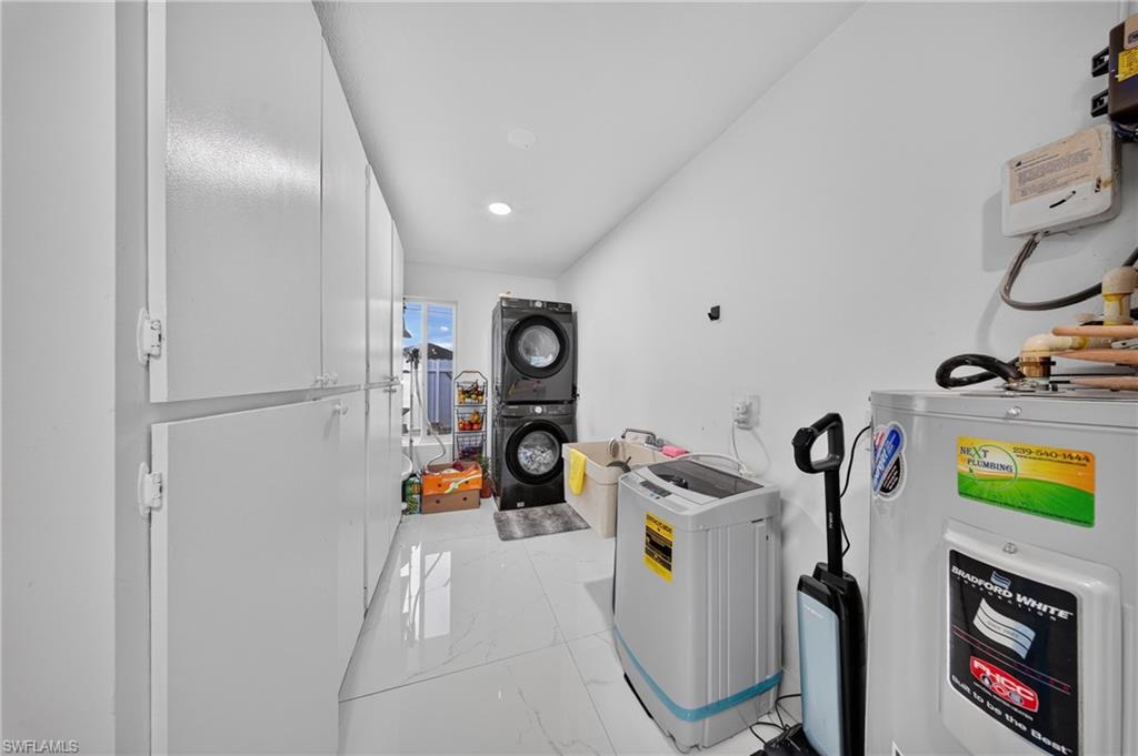White tile flooring, overhead lighting, and built-in white cabinetry